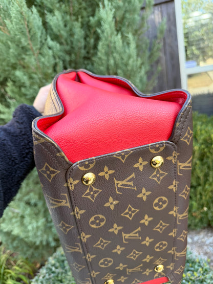 Louis Vuitton Gaia in Monogram Canvas with Red Accent