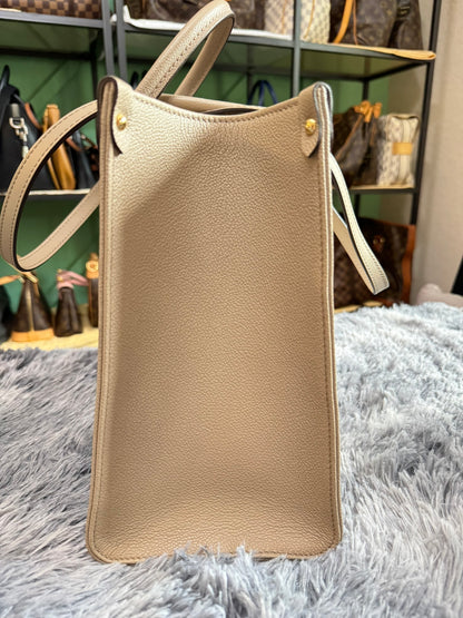 Louis Vuitton OnTheGo MM in Bicolor Monogram Empreinte Leather (Tourterelle/Cream)